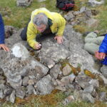 Lichenologists inspecting a limestone outcrop