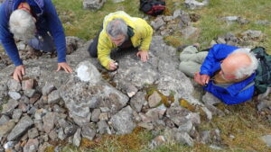 Lichenologists inspecting a limestone outcrop